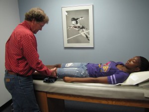 Dr. Bill Barnes treats a student athlete during Piedmont's free Saturday morning clinic